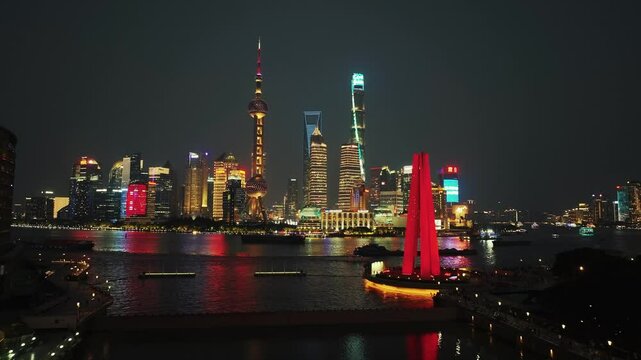 Aerial drone view of modern skyscraper office buildings at night in Shanghai, China, Asia.