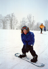 Circa 1996 - Angsty 90s teenager girl on a snowboard at a ski resort. Vintage scan, may have...