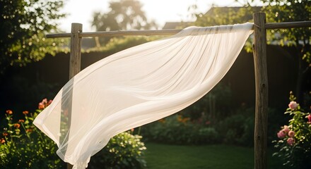 Transparent veil drying on a rustic string between two wooden poles in bright daylight