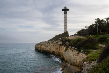 Stunning Torredembarra Lighthouse on rugged Mediterranean cliffs at Punta de la Galera, Tarragona, Catalonia. Perfect seaside nature and maritime beauty.
