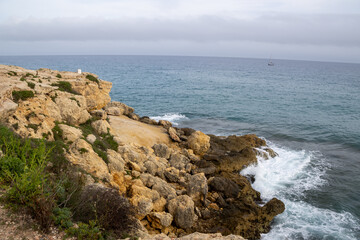 Stunning Torredembarra Lighthouse on rugged Mediterranean cliffs at Punta de la Galera, Tarragona, Catalonia. Perfect seaside nature and maritime beauty.
