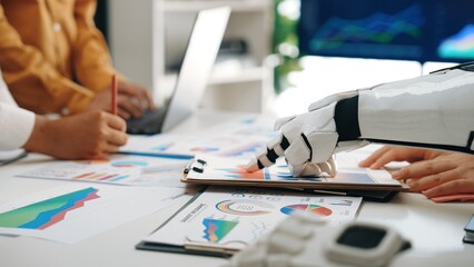 A robotic hand assists professionals in analyzing data and creating business strategies through...