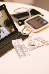 Sick person taking medication by video calling the doctor.