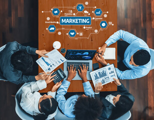 A diverse team of professionals actively collaborates on a marketing strategy, utilizing data...