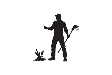 Fototapeta premium Silhouette of a Farmer Working in a Field with a Hand Tool