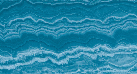 Obraz premium A close up shot of a blue and white marble texture with wavy lines across the surface of the stone