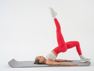 Caucasian woman doing sports exercises on white background. 