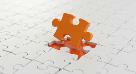 An orange puzzle piece slightly hovering over a missing spot in a white jigsaw puzzle background view