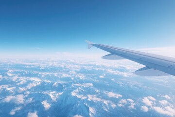 Fototapeta premium airplane wing seen from window with blue sky and cloud layers