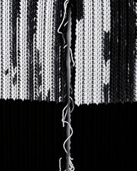 Split Monochrome Knitted Fabric Texture. Frayed Connections – The Fragility of Relationships Concept. Knitted Backgrounds Collection