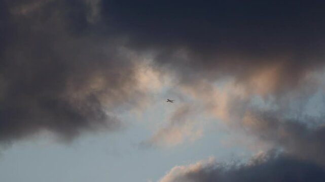 Vintage model aircraft soaring against a cloudy late evening sky, capturing a quiet moment