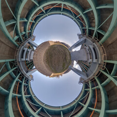 Abstract view of little planet transformation of spherical panorama 360 degrees. Spherical abstract aerial view on steel frame and concrete construction huge car bridge. Curvature of space.
