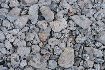 Pile of pebbles on the ground as a background.