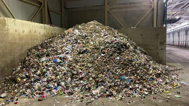 Significant accumulation of various waste materials is found in a recycling facility, showcasing the importance of efficient waste management in urban environments. Close up view approximation