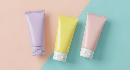 Three pastel colored cosmetic tubes arranged diagonally on a split background of peach and teal