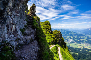Summer mountain hiking in Tyrol (Austria) - a path along the rock in the ascent to the Kitzbüheler...