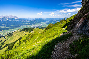 Mountain hiking in Tyrol (Austria) - path along the rock in the ascent to the Kitzbüheler Horn and...