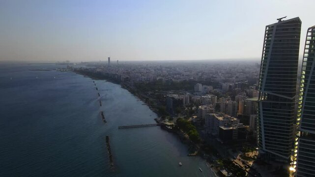 View from above on Limassol buildings, evening Cyprus
High-rise towers of Cyprus. Summer sunset and Mediterranean sea with city traffic in the background