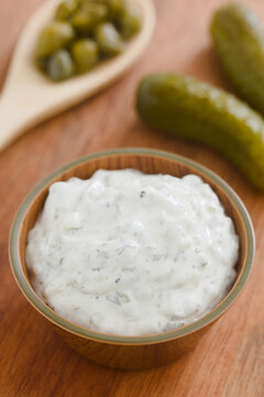 Fresh homemade tartar sauce made of mayonnaise, pickles, capers, herbs, salt and pepper, served in small bowl (Selective Focus, Focus on the front of the sauce)