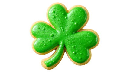 A single shamrock cookie with green icing on a black background viewed from directly above closeup shot .