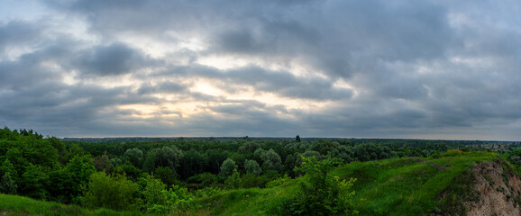 A cloudy dawn gently unfolds over a picturesque village in the Poltava region of Ukraine, casting a...