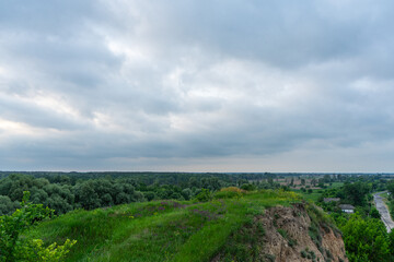 A cloudy dawn gently unfolds over a picturesque village in the Poltava region of Ukraine, casting a...