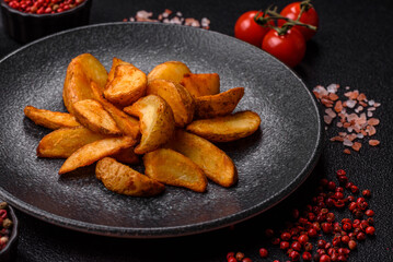 Grilled potato wedges with rosemary, cheese, salt and spices. Baked potato slices