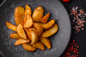 Grilled potato wedges with rosemary, cheese, salt and spices. Baked potato slices