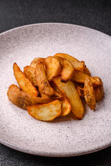 Grilled potato wedges with rosemary, cheese, salt and spices. Baked potato slices