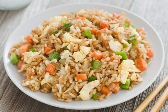 Homemade vegetarian fried rice made with onion, white cabbage, carrot, green pepper, soy sauce, oyster sauce, sesame oil and scrambled eggs (Selective Focus, Focus in the middle of the image)