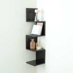 Dark corner zigzag wall shelf with minimalist decorative setup featuring blush flowers in glass...