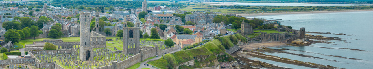 Aerial view of St Andrews a town on the east coast of Fife in Scotland. St Andrews Cathedral and castle, view of the coast and its green areas