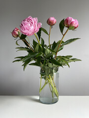 Fototapeta premium Pink Peony Bouquet in Clear Glass Vase on Soft Background