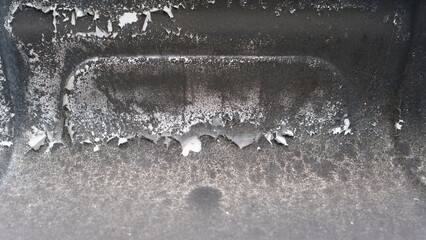 A detailed image highlighting the peeling paint and rust on the surface of a well-used barbecue...