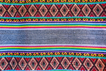 Colorful hand-woven Inca textile background with ancient designs from the Andes mountain range of...