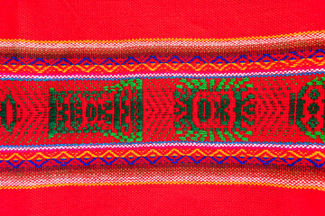 Colorful hand-woven Inca textile background with ancient designs from the Andes mountain range of...
