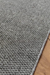 Grey carpet in the room or hallway. Vertical. Texture closeup. Fluffy pile
