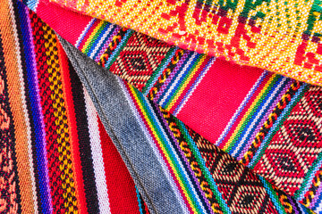 Colorful hand-woven Inca textile background with ancient designs from the Andes mountain range of...