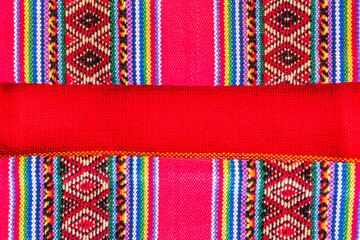 Colorful hand-woven Inca textile background with ancient designs from the Andes mountain range of...