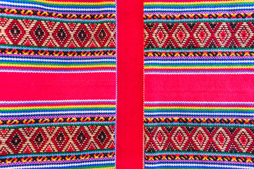 Colorful hand-woven Inca textile background with ancient designs from the Andes mountain range of...