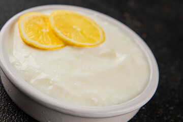 Lemon yogurt natural product skyr sour milk skir fresh delicious gourmet food background on the table rustic food top view copy space keto and paleo diet vegetarian food