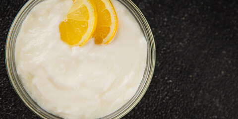 Lemon yogurt natural product skyr sour milk skir fresh delicious gourmet food background on the table rustic food top view copy space keto and paleo diet vegetarian food