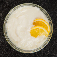 Lemon yogurt natural product skyr sour milk skir fresh delicious gourmet food background on the table rustic food top view copy space keto and paleo diet vegetarian food