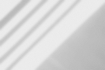 Window Shadow Overlay with Light Blur Effect on White Wall in Summer Sunlight