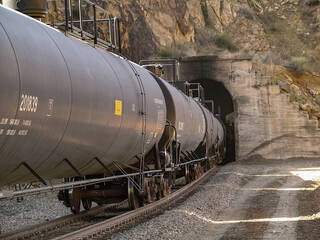 Tank car train into mountain tunnel
