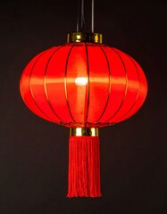 Vibrant Red Chinese Lantern with Golden Accents on Black Background
