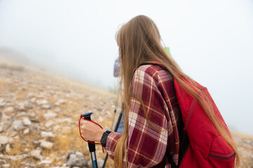 Hiker Exploring Foggy Mountain Trail on a Misty Morning with Backpack