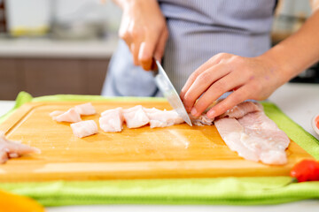 Chef cutting fish for peruvian ceviche preparation in kitchen