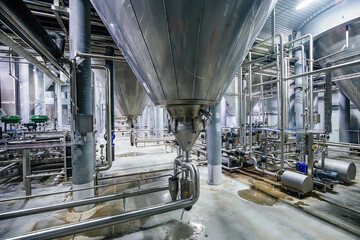 Large industrial stainless steel vats for fermentation in modern brewery