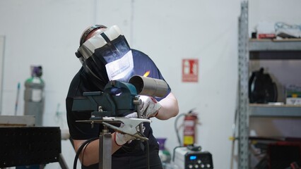 Skilled welder using tig welding to join metal pipes, showcasing precision and expertise in a...